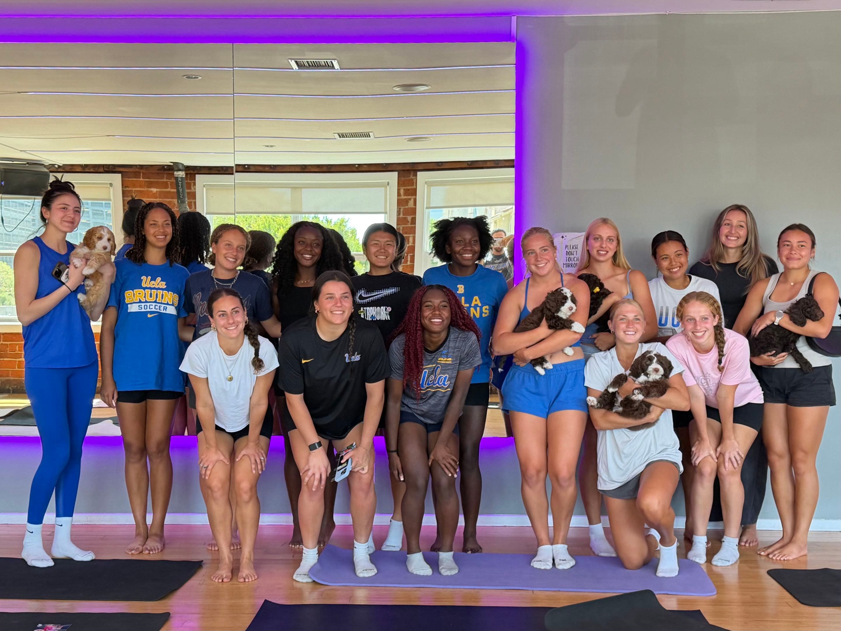 UCLA group celebrating a private puppy yoga class